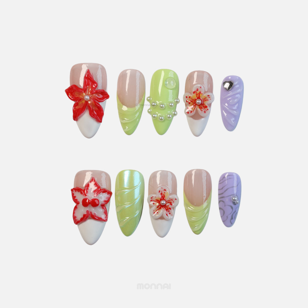 Orchid Glow press-on nails laid out with red 3D floral accents, lime green swirls, lavender detail and pearls