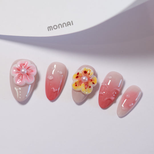 Peach Petals press-on nails laid out with pink ombre and 3D floral pearl accents