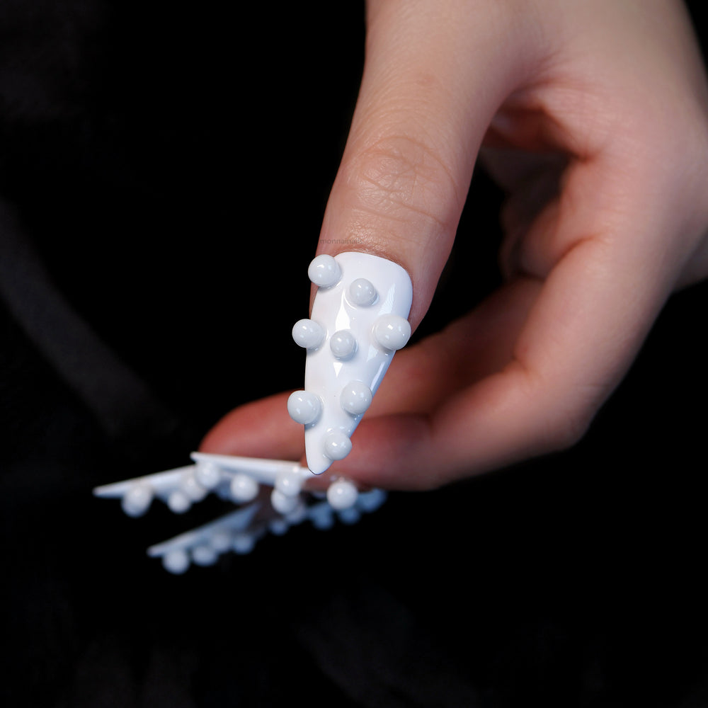 Pearl Bubbles press-on nails in close-up, white sculptural 3D bubble accents on a sheer white base.