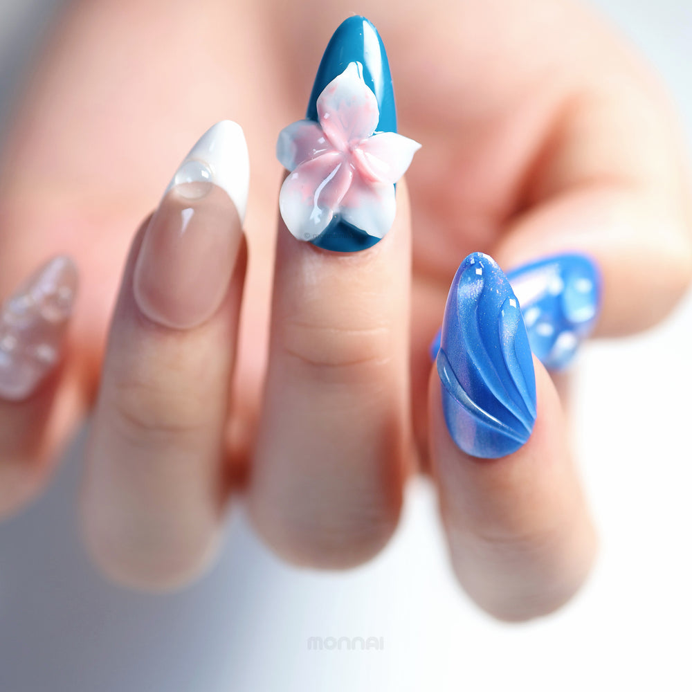 Petal Waves press-on nails on hand, blue set with soft pink 3D flower, glossy raised details and shimmer