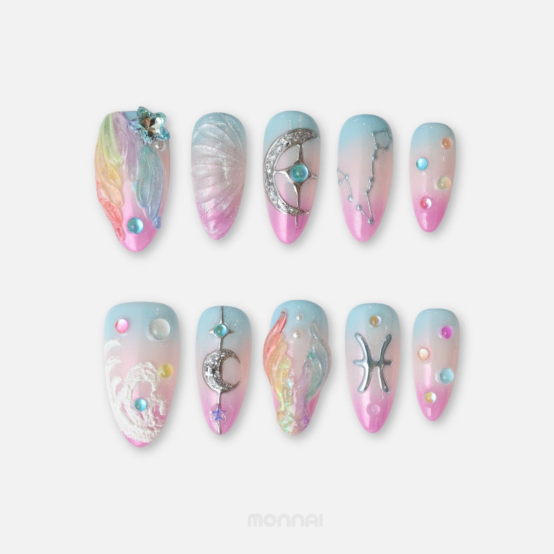 Pisces press on nails from the Zodiac Collection, featuring pastel blue and pink tones, pearlescent shells, moons and celestial details.
