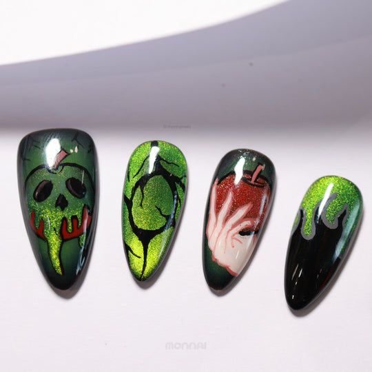 Poison Apple press-on nails laid out, with dark magic art and hand-painted poison apples on green and purple cat eye bases.