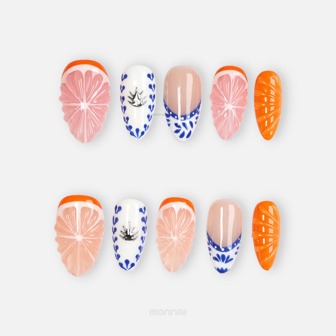 Porcelain Orchard press-on nails laid out in citrus-inspired pink, nude, blue, and orange designs with glossy accents.
