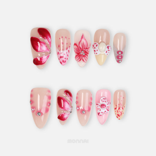 Pretty Petal Party press-on nails laid out with pink floral accents, nude bases, rhinestones, and glossy petal details.