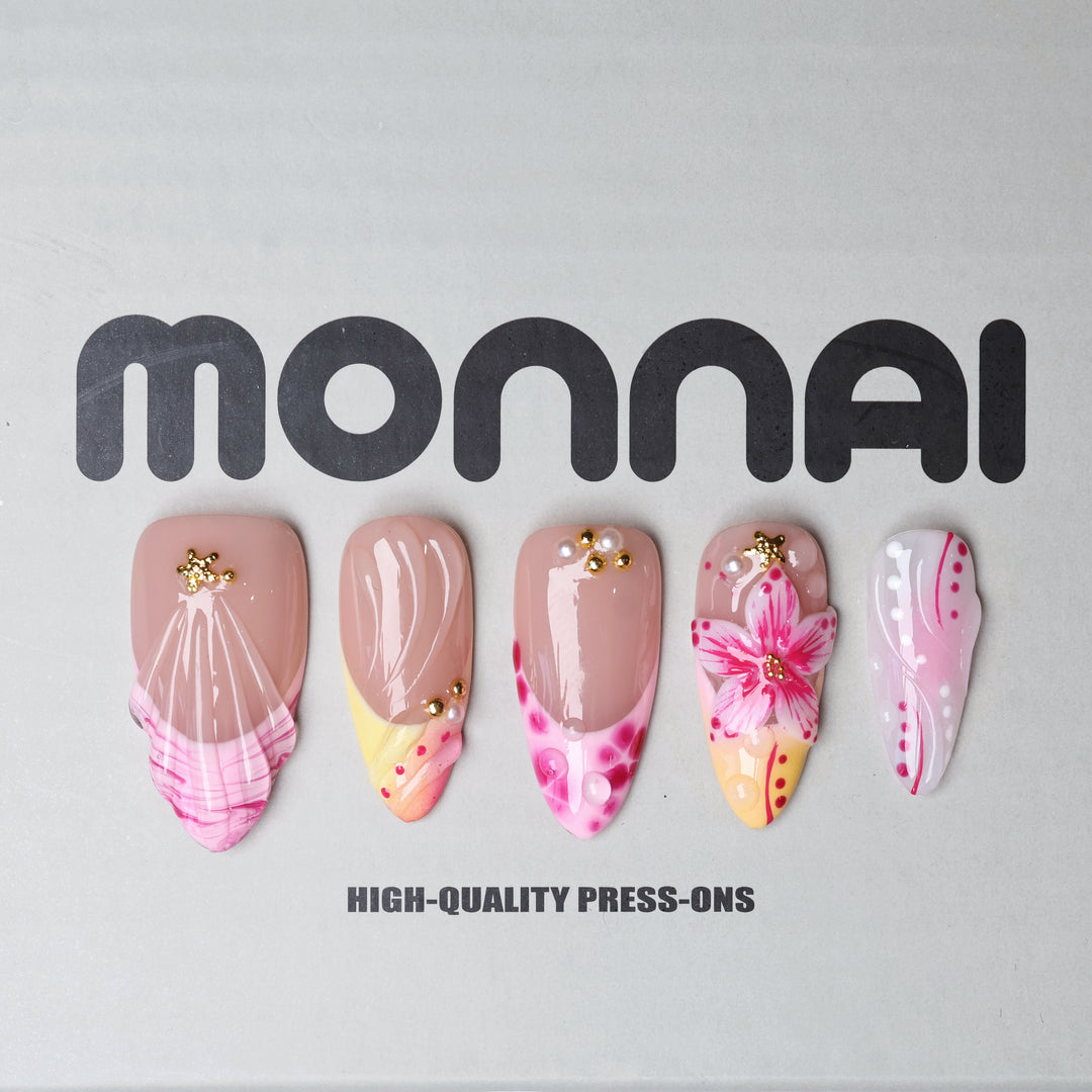 Pretty in Pink press-on nails laid out with jelly nude base, pink florals, gold star accents, and glossy iridescent details