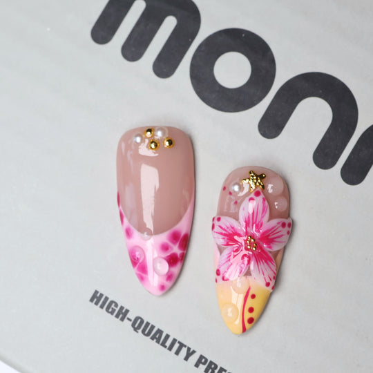 Pretty in Pink press-on nails laid out, showcasing jelly nude, pink floral art, 3D blooms, gold stars, and dew drops.
