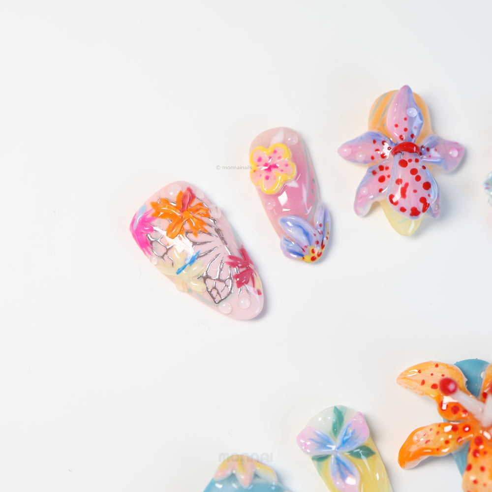 Radiant Bloom press-on nails laid out in close-up, with oversized 3D flowers, jelly layers, and glossy candy-like details.