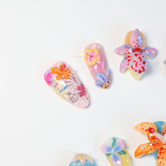 Radiant Bloom press-on nails laid out in close-up, with oversized 3D flowers, jelly layers, and glossy candy-like details.