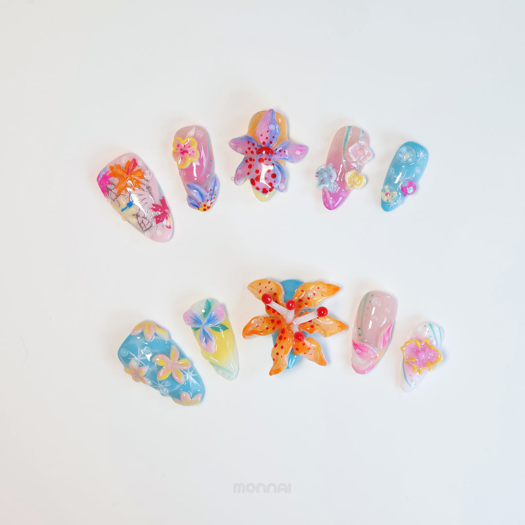 Radiant Bloom press-on nails laid out with oversized 3D flowers, jelly-like translucent layers, and dreamy candy colors.