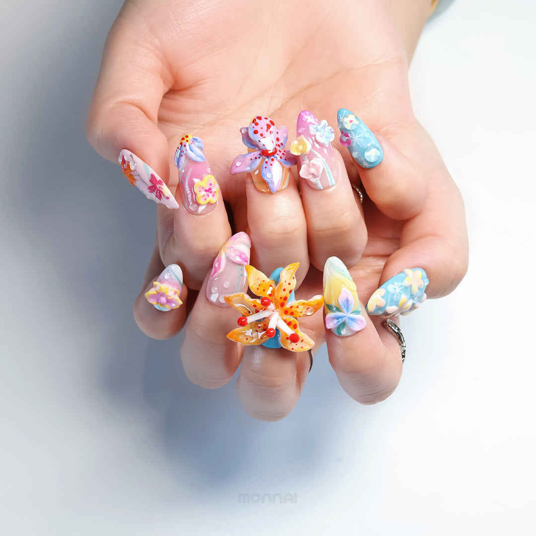 Radiant Bloom press-on nails worn on hand, with oversized 3D flowers and dreamy soft pastel candy-like details.