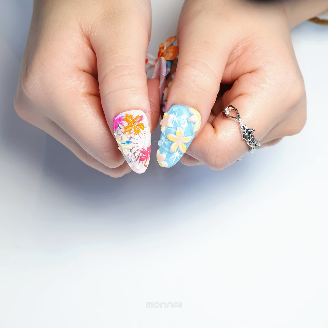 Radiant Bloom press-on nails in close-up, with dreamy candy-like 3D flowers, soft blue and pink translucent layers.
