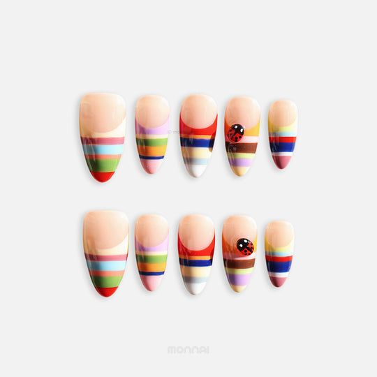Rainbow Stripes press-on nails, full set with nude base, colorful horizontal stripes and ladybug accent, playful