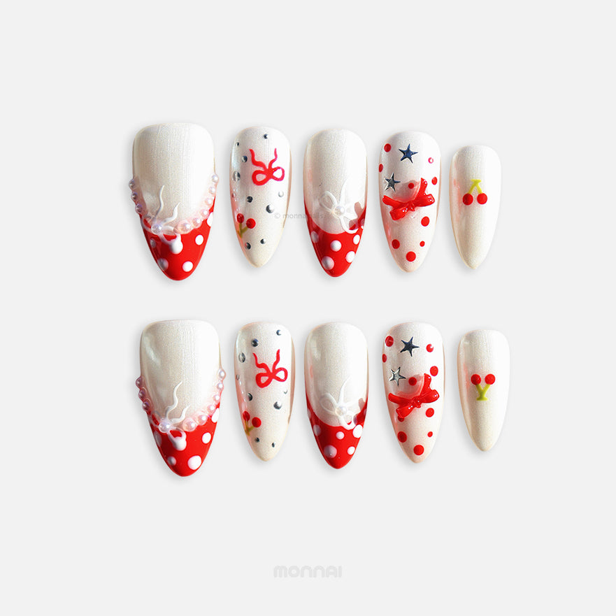 Red Dot Bow press-on nails set with pearl white shimmer, red polka dots, ribbon bows, stars and cherry accents