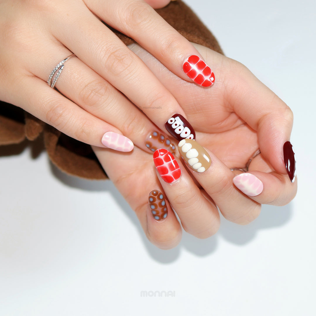 Retro Groove press-on nails worn on hands with retro color-blocking, abstract animal prints, and glossy red, brown, and pink shades.