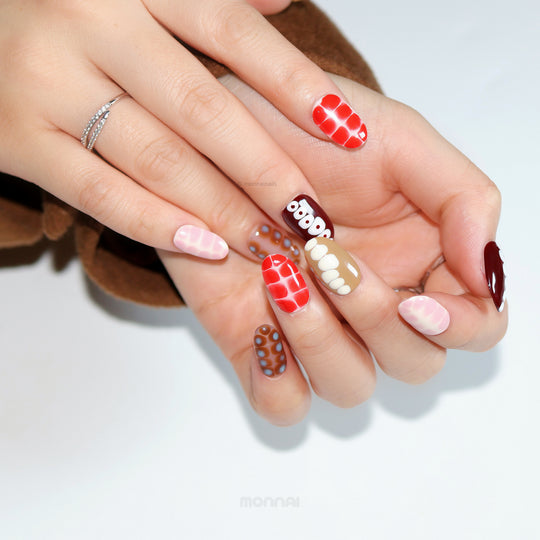 Retro Groove press-on nails worn on hands with retro color-blocking, abstract animal prints, and glossy red, brown, and pink shades.