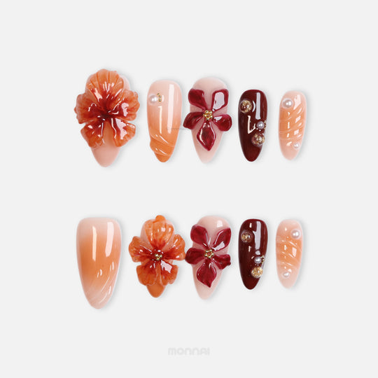 Rustic Elegance press-on nails laid out in close-up, with coral and deep berry 3D flowers, soft gradients, and gold accents