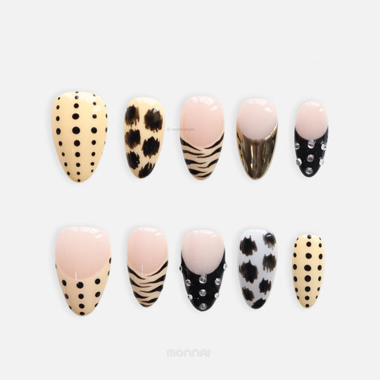 Safari Chic press-on nails in safari theme, shown laid out with polka dots, zebra stripes, animal spots, and gold chrome accents.