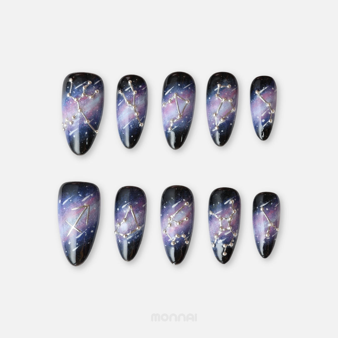 Sagittarius press on nails from the Zodiac Collection, with a deep galaxy base, silver constellation details and celestial metallic accents.