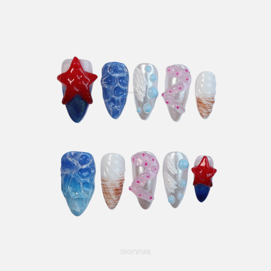 Seaside Fantasy press-on nails laid out with red starfish, blue water ripples, pink tentacles and silver ocean accents.