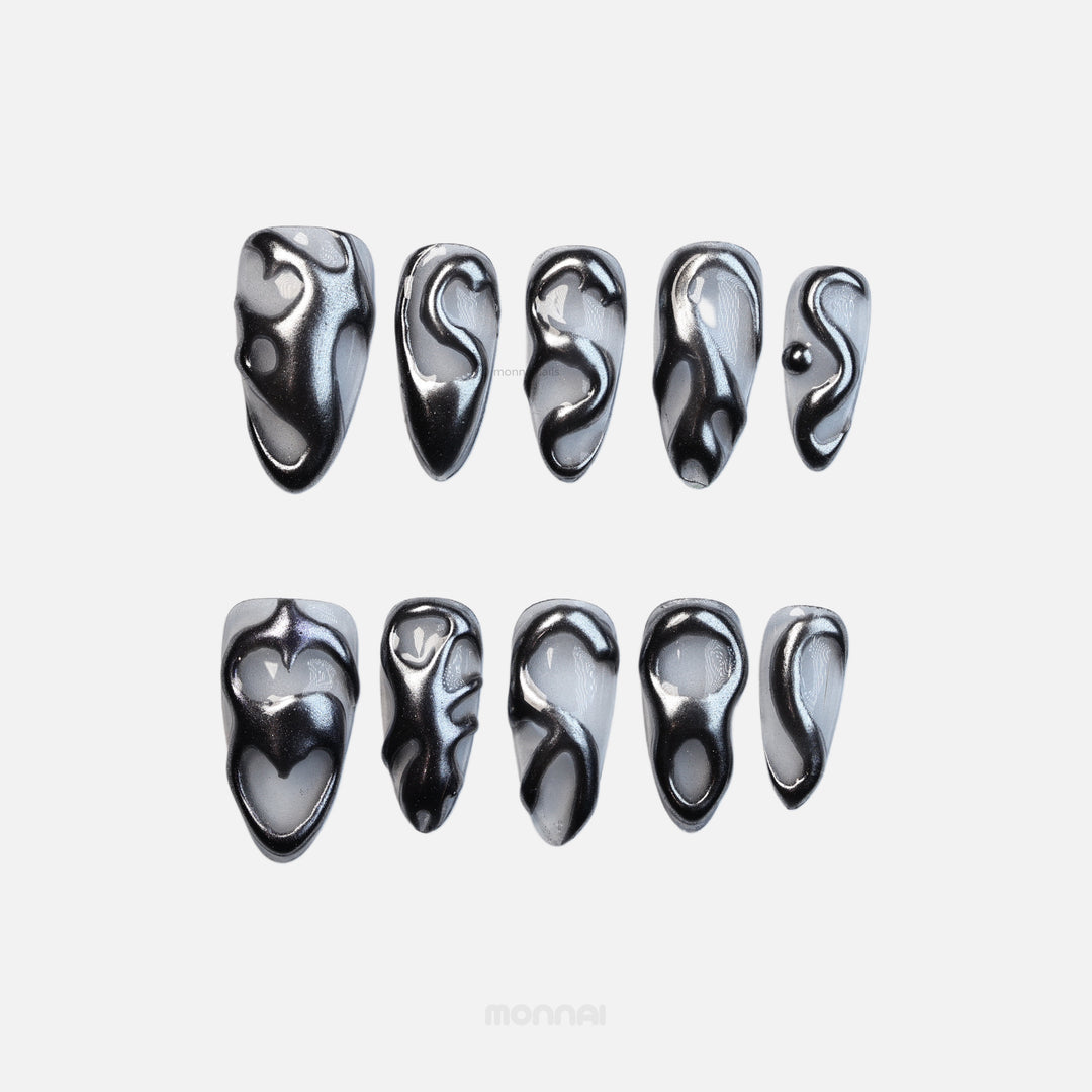 Silver Mystic Flow press-on nails set with liquid chrome silver sculptural swirls, shown laid out in close-up.
