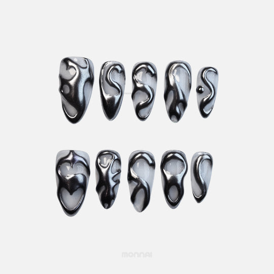 Silver Mystic Flow press-on nails set with liquid chrome silver sculptural swirls, shown laid out in close-up.