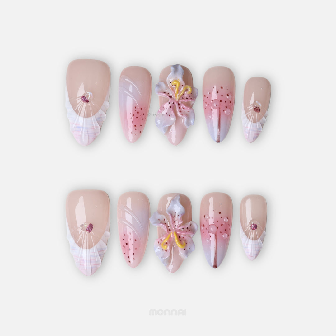 Somewhere in Time press-on nails laid out with 3D orchids, soft purple ombre, shell-textured French tips and jewels