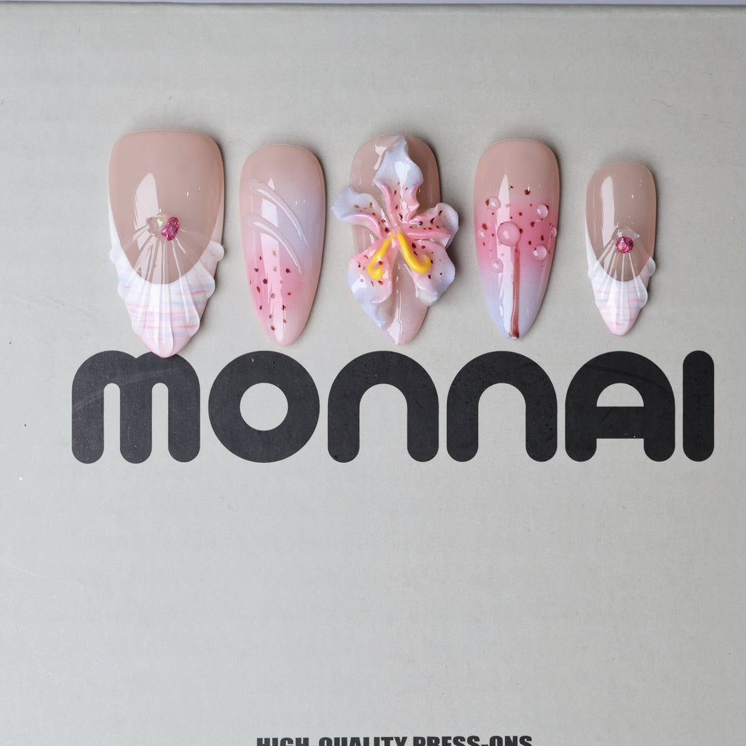 Somewhere in Time press-on nails laid out with soft purple ombre, 3D orchid accents, jewels and shell-textured French tips.