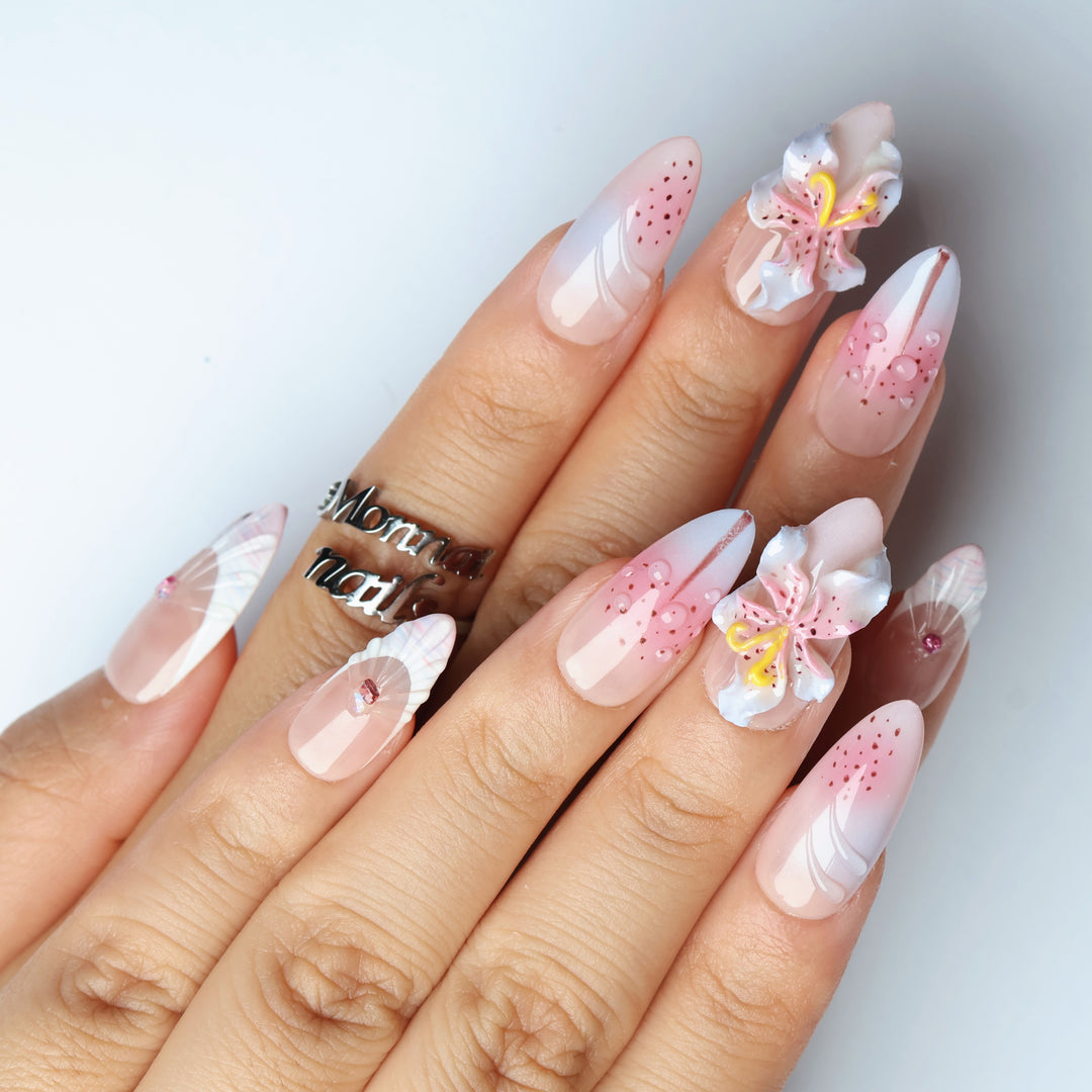Somewhere in Time press-on nails on hand, soft purple ombre with 3D orchids, dew drops and shell French tips