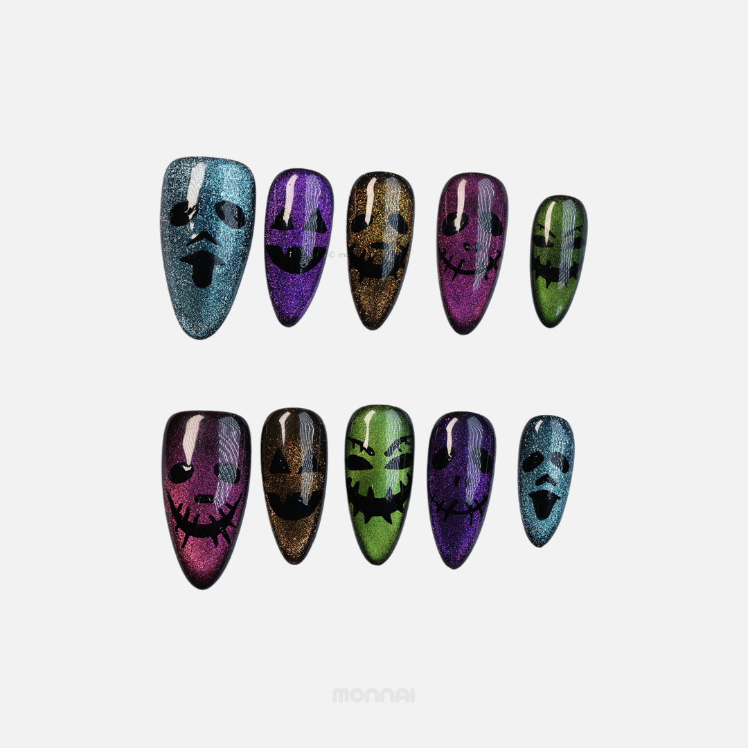 Spooky Spark press-on nails with shimmering cat eye Halloween faces in blue, purple, gold and green.