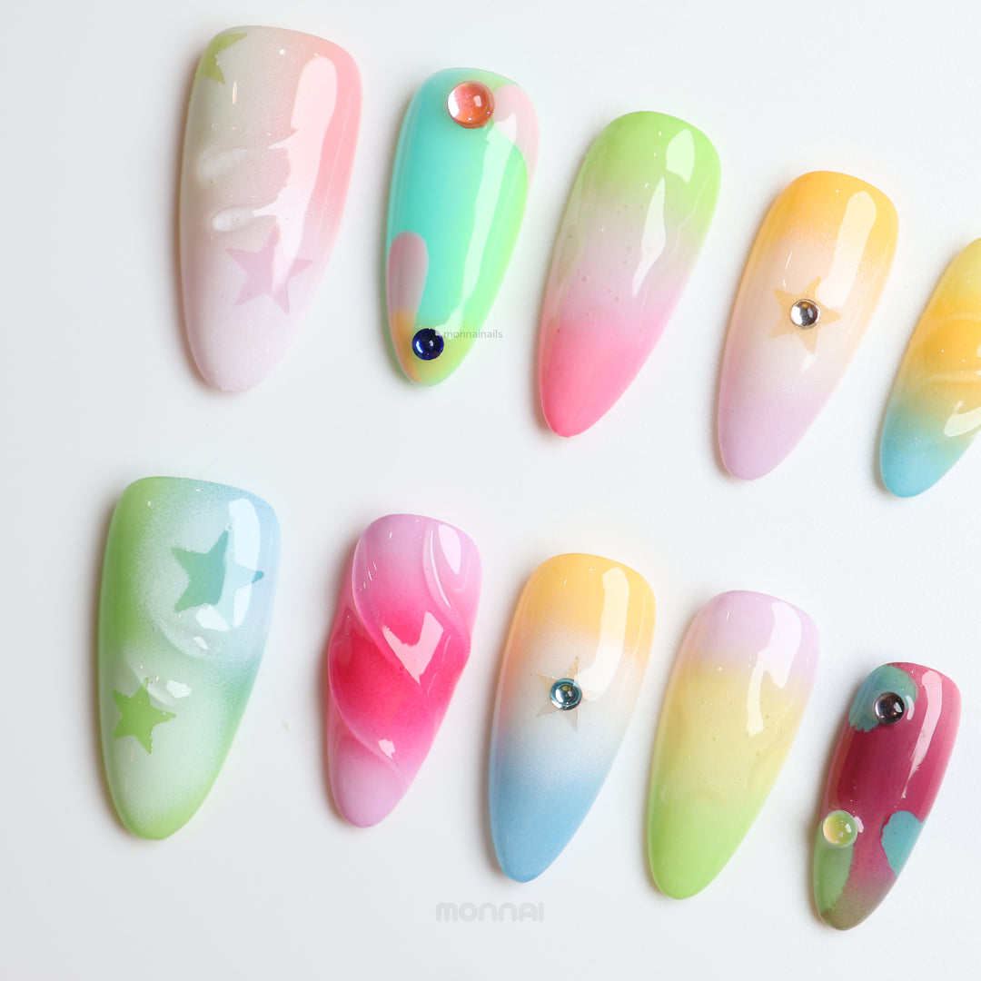 Starlight Pastels press-on nails laid out in soft pastel fades with glossy raised star and bead details.