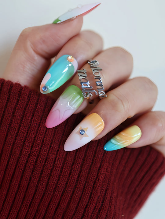 Starlight Pastels press-on nails worn on hand, with mint, pink, yellow and lilac glossy star accents