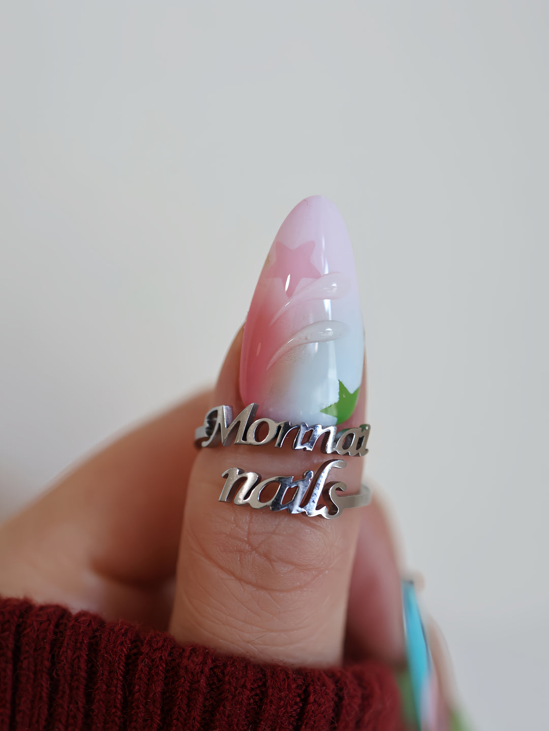 Starlight Pastels press-on nails on hand, airy pastel fade with glossy star accents and raised details