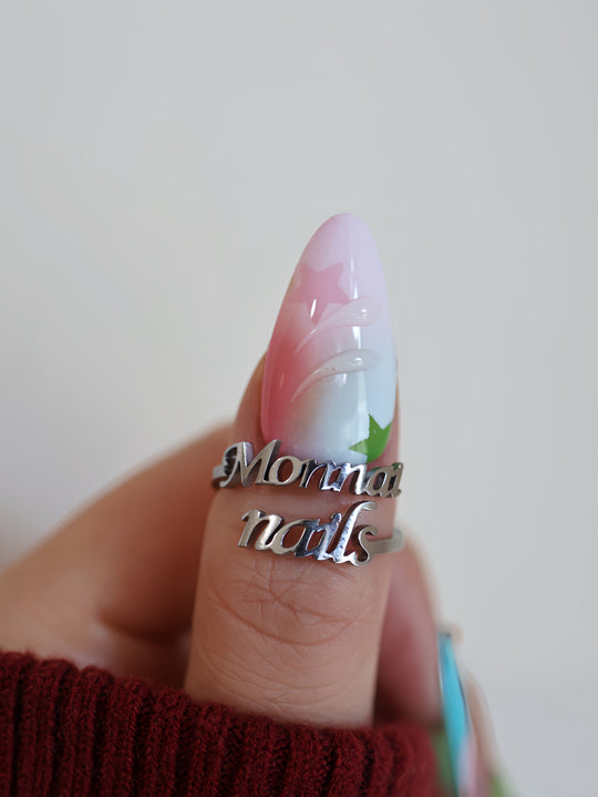 Starlight Pastels press-on nails on hand, airy pastel fade with glossy star accents and raised details