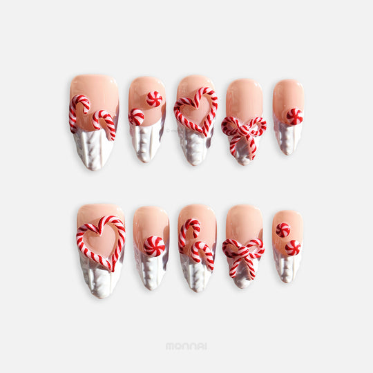 Sugar Kiss press-on nails laid out with nude, white knit texture, and red candy cane heart and bow designs