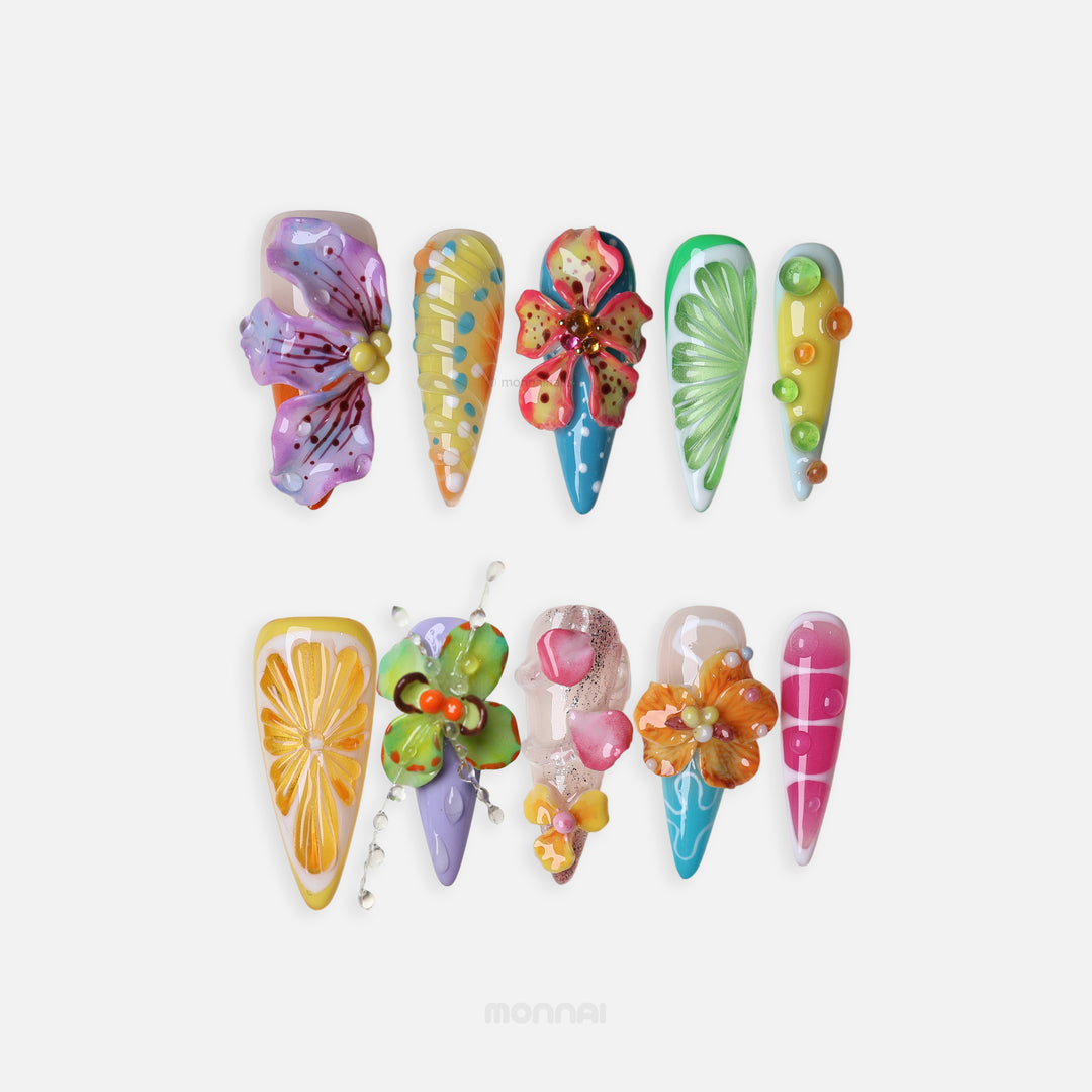Summer Garden Party press-on nails laid out in colorful tropical floral and citrus 3D designs