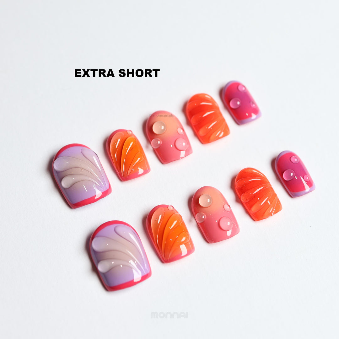 Sunset Flow extra short press-on nails laid out with bold red, purple and orange glossy bubble accents