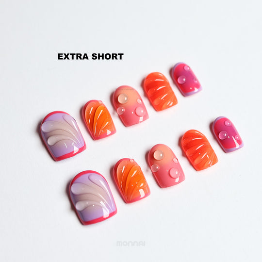 Sunset Flow extra short press-on nails laid out with bold red, purple and orange glossy bubble accents