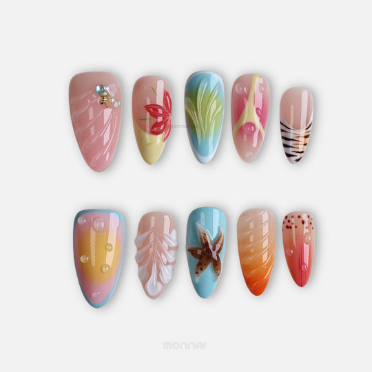 The Beach press-on nails laid out, with seafoam blue, sunset gradients, 3D starfish, shell textures and water droplet accents.