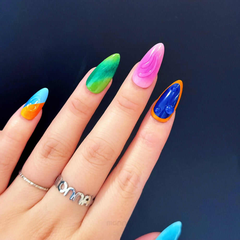 Tropical Vibes press-on nails worn on hand with bright mismatched colors and clear gel 3D accents