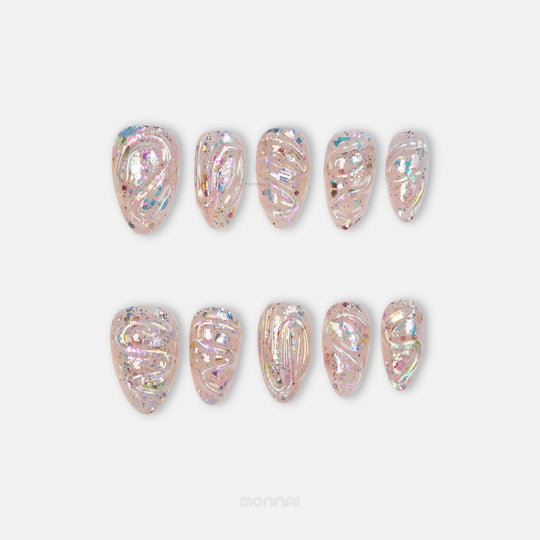 Twinkle press-on nails with sheer nude base, iridescent glitter, and glossy sculpted texture