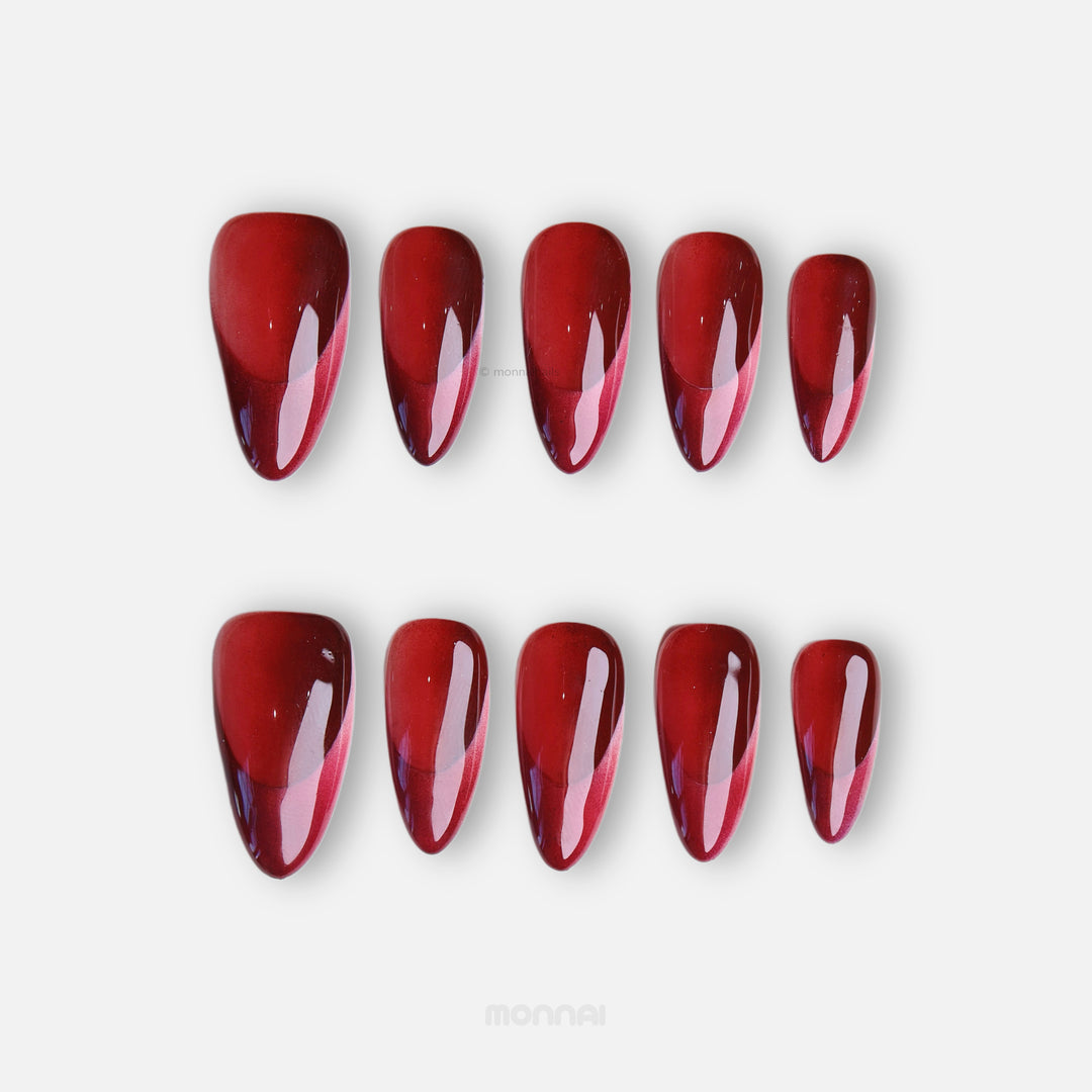 Vampire’s Kiss press-on nails in rich monochromatic red with a high-gloss finish, shown laid out in two rows.