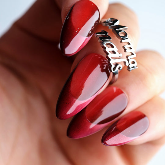 Vampire’s Kiss press-on nails shown on hand in close-up, deep saturated red with a glossy finish