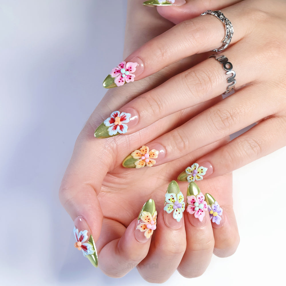 Vibrant Blossoms press-on nails shown on hands, with 3D mixed-color flowers, nude base and olive green French tips.