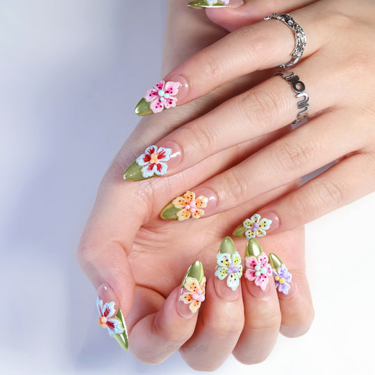 Vibrant Blossoms press-on nails shown on hands, with 3D mixed-color flowers, nude base and olive green French tips.