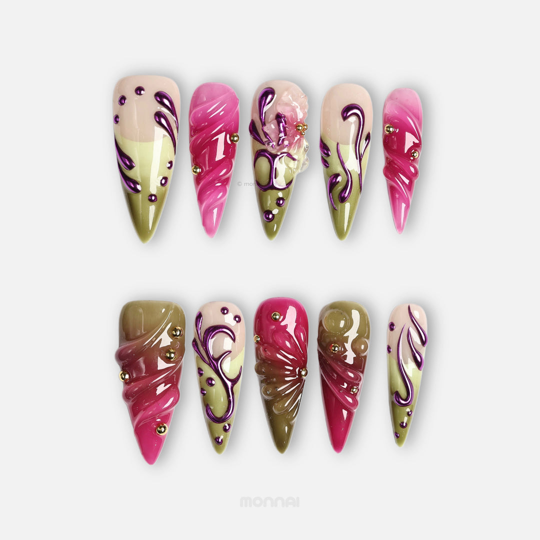 Vine press-on nails in bold Y2K pink and olive with metallic purple swirls and gold studs, laid out in a set