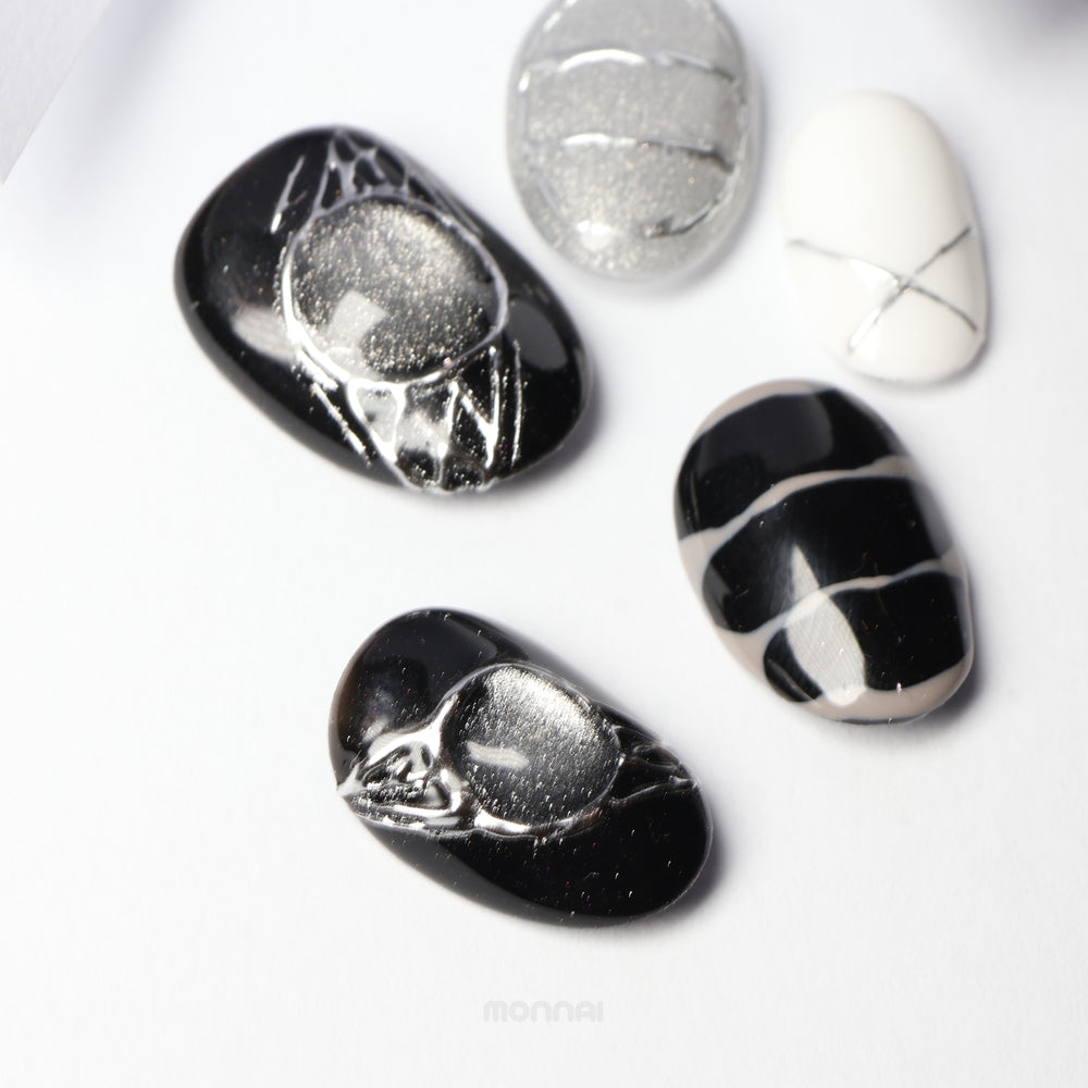 Void Spark press-on nails laid out in black, silver, and white with chrome accents and abstract fine linework