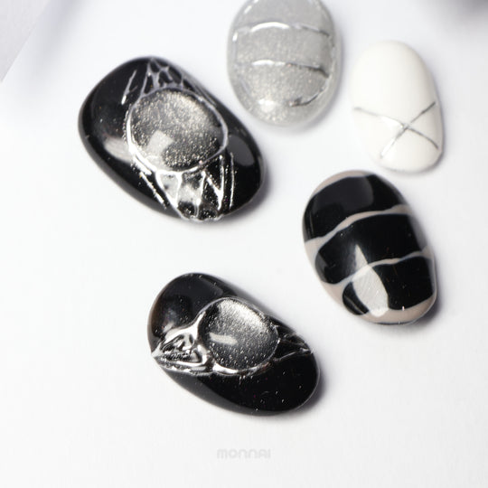 Void Spark press-on nails laid out in black, silver, and white with chrome accents and abstract fine linework