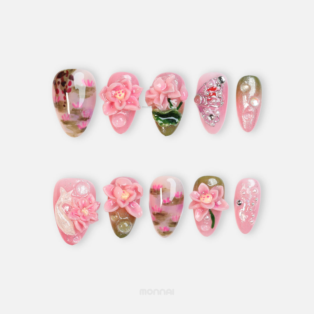 Water Lily Dream press-on nails, laid out with hand-painted pink pond florals and glossy shimmer.