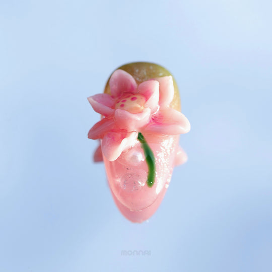 Water Lily Dream press-on nails in close-up, showing a glossy pink sculpted water lily with soft painterly shimmer.