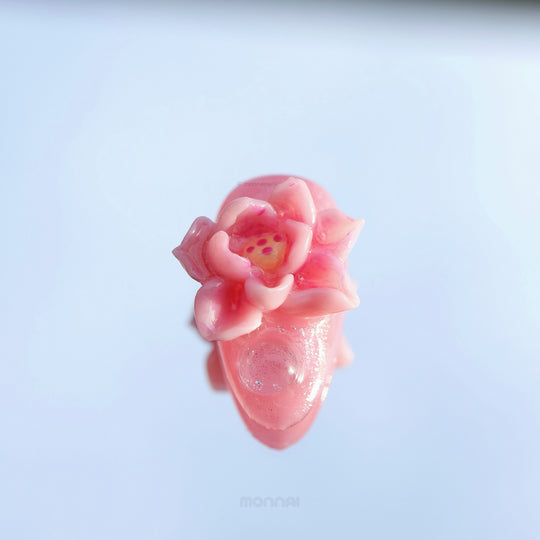 Water Lily Dream press-on nails in close-up, showing a glossy pink hand-painted floral design with sculpted water lily details.